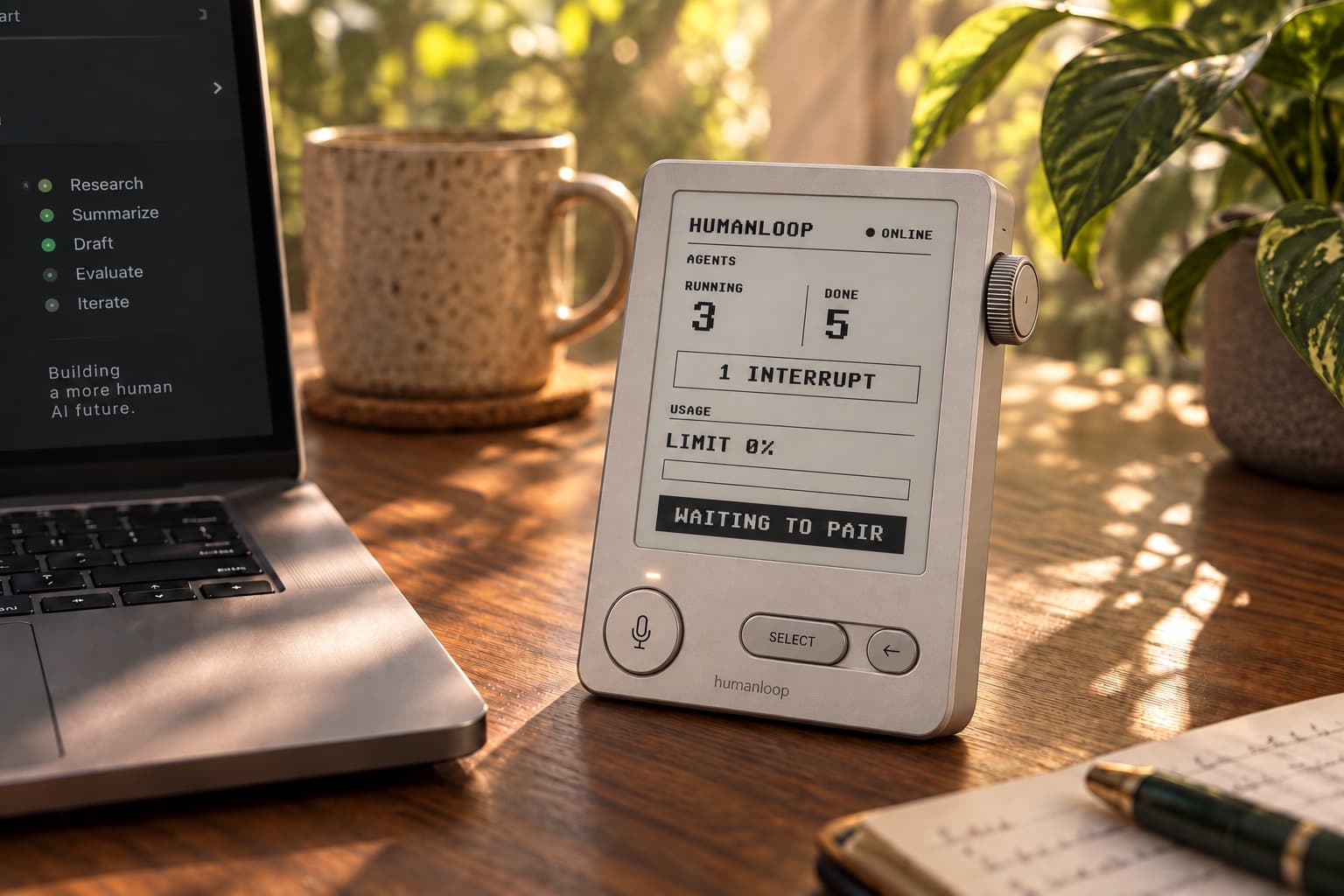 Humanloop e-paper device with a microphone button and rotary encoder on a sunlit desk